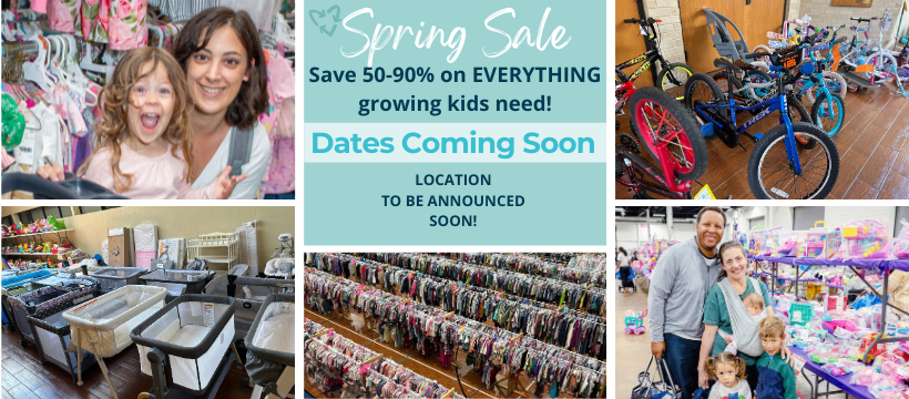 A mom and her child hug in between two rows of little girl clothes